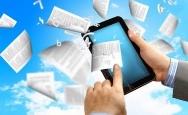 Students buying e-books chapter by chapter Image via shutterstock.com