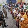 Security personnel maintaining queues of voters at a polling station during Bihar assembly elections. Photo: PTI
