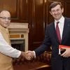 Union Minister for Finance, Corporate Affairs and Information &amp; Broadcasting, Arun Jaitley shakes hand with Vodafone Group CEO Vittorio Colao during a meeting in New Delhi
