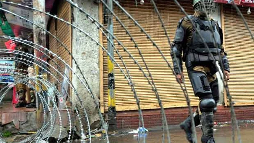 A security personnel stands guard during a bandh in Kashmir A security personnel stands guard during a bandh in Kashmir