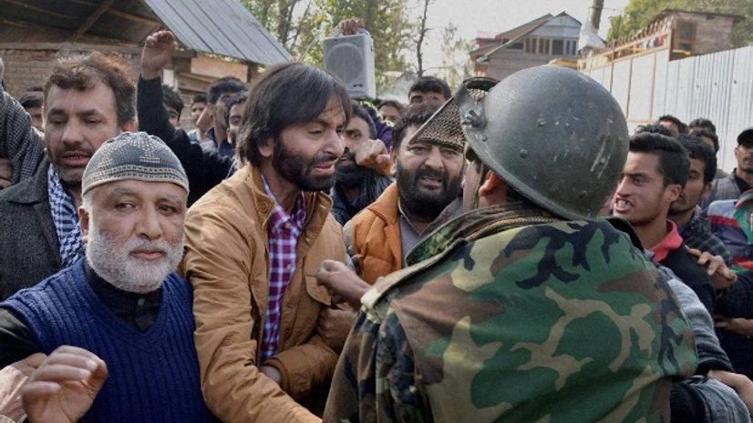 Police arrest JKLF chairman Mohd Yasin Malik along with supporters after he tried to defy restrictions and take out a rally, at Batangoo in Anantnag district Police arrest JKLF chairman Mohd Yasin Malik along with supporters after he tried to defy restrictions and take out a rally, at Batangoo in Anantnag district