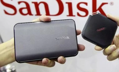 Western Digital to buy SanDisk for $19 billion Sandisk's new portable solid state drives are displayed at the Sandisk booth during the 2015 Computex exhibition at the TWTC Nangang exhibition hall in Taipei, Taiwan
