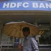 A customer walks outside an HDFC Bank branch in Mumbai