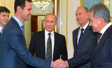 Russia to respond promptly, harshly to future incursions: Defence minister In this photo taken on Tuesday, Oct. 20, 2015, Syrian President Bashar Assad, second left, shakes hand with Russian Defense Minister Sergei Shoigu, as Russian President Vladimir Putin, center, looks on in the Kremlin in Moscow, Russia.
