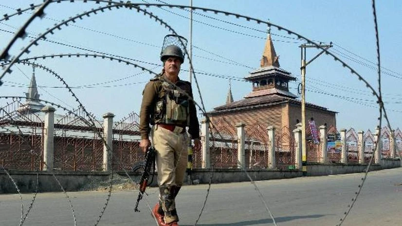 A security jawan guards at a street during restrictions imposed by the authorities to thwart protests by separatists, in Srinagar A security jawan guards at a street during restrictions imposed by the authorities to thwart protests by separatists, in Srinagar
