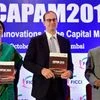 Managing Director &amp; CEO of National Stock Exchange Chitra Ramkrishna along with Mark Wiseman, President and CEO, Canada Pension Plan Investment Board (CPPIB) and SEBI Chairman, U K Sinha release a report during FICCI's CAPAM 2015 in Mumbai