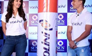 Pharma firms expand focus on OTC segment Tennis player Sania Mirza with captain of Indian football team Sunil Chhetri after being announced as new brand ambassadors of 'Volini' during a press conference in Mumbai