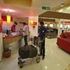 An attendant holds a trolley loaded with the luggage of a guest at the reception area of a hotel in Ahmedabad May 5, 2012. Photo: Reuters