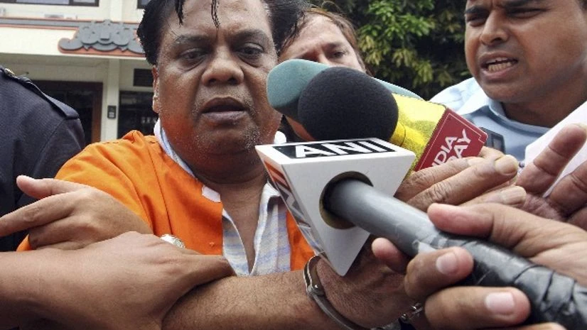 Indian fugitive Rajendra Sadashiv Nikalje, known in India as "Chotta Rajan," left, is escorted by plain-clothed police officers for questioning in Bali, Indonesia Indian fugitive Rajendra Sadashiv Nikalje, known in India as "Chotta Rajan," left, is escorted by plain-clothed police officers for questioning in Bali, Indonesia