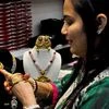 A woman checking gold bangles