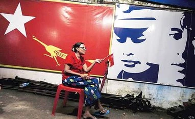Myanmar president 'will hand power' to Suu Kyi after poll win A supporter of Myanmar's pro-democracy figurehead Aung San Suu Kyi sits inside National League for Democracy headquarters in Yangon, Myanmar