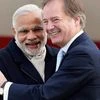 Prime Minister Narendra Modi with Hugo Swire, Minister of State at the Foreign and Commonwealth Office, at Heathrow Airport on November 12, 2015. -- PTI Photo