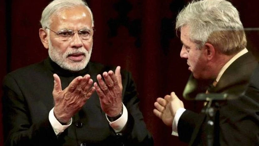 Prime Minister Narendra Modi acknowledges applause after addressing the Members of Parliament at the UK Parliament's Royal Gallery in London. PTI Photo Prime Minister Narendra Modi acknowledges applause after addressing the Members of Parliament at the UK Parliament's Royal Gallery in London