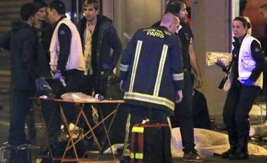 'Devastated' U2 cancels Paris concert following terror attacks Rescue workers at the scene as victims lay on the pavement outside a Paris restaurant. Photo: AP/PTI