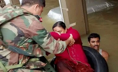 Toll touches 87, Tamil Nadu limping back to normalcy Army personnel rescuing people during their flood relief operations in rain-hit areas of Chennai