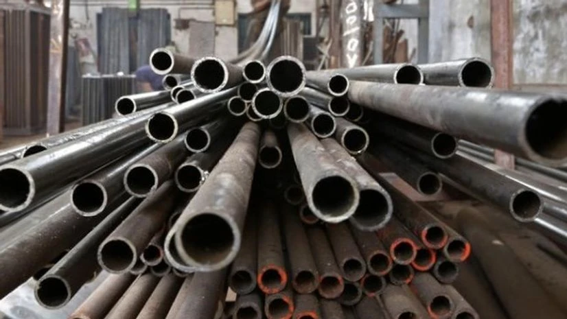 A worker stacks steel pipes in Ahmedabad A worker stacks steel pipes in Ahmedabad