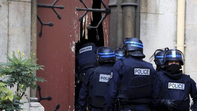 French police officers storm a church after a raid in Paris suburb Saint-Denis French police officers storm a church after a raid in Paris suburb Saint-Denis
