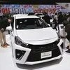 Visitors look at Toyota Motor Corp’s G’s Prius Alpha at the 44th Tokyo Motor Show in Tokyo