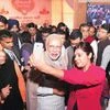 Prime Minister Narendra Modi poses for a selfie with reporters during the Diwali Mangal Milan at the BJP headquarters in New Delhi on Saturday