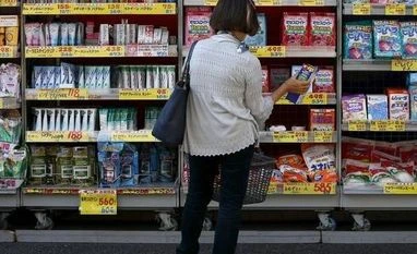 Tokyo December core consumer prices fall at fastest pace in over a decade A woman looks at items at a discount drug store at a shopping district in Kamakura, south of Tokyo, Japan. Photo: Reuters