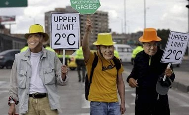 Rich nations have duty to lead climate change action: Modi Demonstrators with masks depicting U.S. President Barack Obama, left, Russian President Vladimir Putin, center, and Chinese Premier Li Keqiang, who will attend the COP21 climate change conference in Paris, take part in a silent march calling for ambi