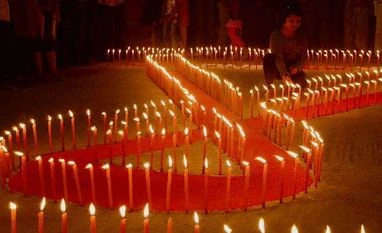 AIDS toll halved since 2006, but still claimed 1 mn lives last year: UN A girl light candles during an AIDS awareness campaign. Photo: PTI