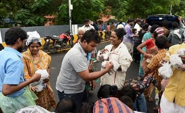 Chennai floods: Discharge from Chembarambakkam lake inundates new areas People rescued at waterlogged houses of Kotturpuram, receiving food packets while sheltering at a road following rains in Chennai