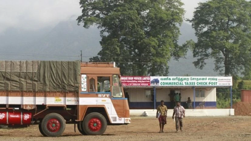 Truck drivers walk out of a Commercial Taxes Department check post after getting clearance to cross a checkpoint with their goods at the Chavadi checkpoint on the outskirt of Coimbatore in Tamil Nadu Truck drivers walk out of a Commercial Taxes Department check post after getting clearance to cross a checkpoint with their goods at the Chavadi checkpoint on the outskirt of Coimbatore in Tamil Nadu