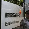 A security guard stands next to an Essar Group logo outside the headquarters in Mumbai. Photo: Reuters
