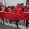 Climate activists carry a red banner during a demonstration at the COP21, United Nations Climate Change Conference, in Le Bourget, north of Paris