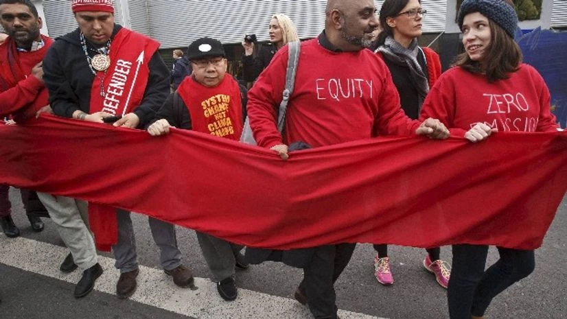 Climate activists carry a red banner during a demonstration at the COP21, United Nations Climate Change Conference, in Le Bourget, north of Paris Climate activists carry a red banner during a demonstration at the COP21, United Nations Climate Change Conference, in Le Bourget, north of Paris