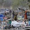 People collect their belongings after a demolition drive carried out by railways in Shakur Basti of Delhi