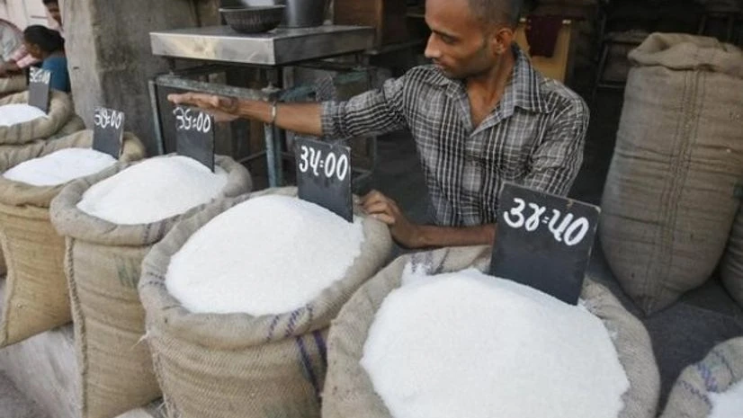 A vendor arranges price tag over sack filled with sugar at wholesale vegetable market in Ahmedabad A vendor arranges price tag over sack filled with sugar at wholesale vegetable market in Ahmedabad