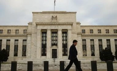 Fed readies first hike in almost a decade amid calm markets A man walks past the Federal Reserve in Washington