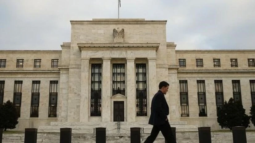 A man walks past the Federal Reserve in Washington A man walks past the Federal Reserve in Washington