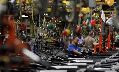 US industrial output falls as manufacturing stays flat Workers perform assembly on SUV chassis at a car assembly plant in Arlington, Texas