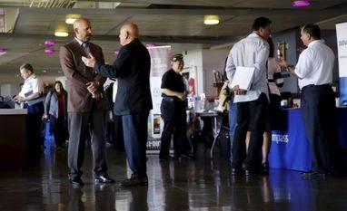 US jobless claims near 42-year low as labour market tightens Recruiters and job seekers gather at a military job fair in San Francisco, California