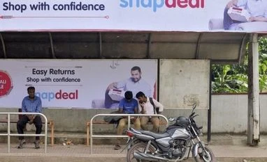 Snapdeal to waive seller charges for COD orders returned after demonetisation Commuters sit at a bus stop adorned with an advertisement of Indian online marketplace Snapdeal featuring Bollywood actor Aamir Khan, in Bengaluru