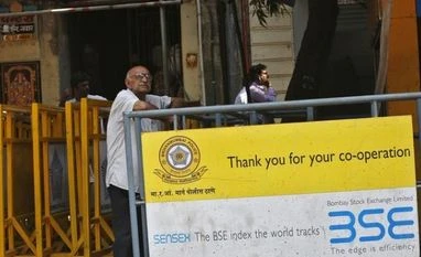 Contrarian calls to tide over volatile markets A man looks at a screen across the road displaying the Sensex on the facade of the Bombay Stock Exchange (BSE) building in Mumbai
