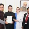 Minister of State for Home Affairs, Kiren Rijiju presenting the Certificate of Indian Citizenship by Naturalization to noted singer and musician Adnan Sami, in New Delhi on Friday.  Additional Secretary (Foreigners), MHA, B.K. Prasad and Roya Faryabi