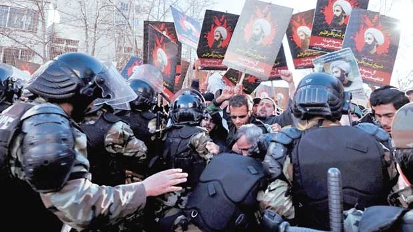 Demonstrators holding pictures of Shi'ite cleric Sheikh Nimr al-Nimr protest outside the Saudi Arabian Embassy in Tehran Demonstrators holding pictures of Shi'ite cleric Sheikh Nimr al-Nimr protest outside the Saudi Arabian Embassy in Tehran
