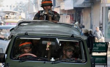 Pathankot attack: Combing operations on to sanitise air base Security forces person guards near the Indian Air Force base where an operation is carried out following the militants' attack, in Pathankot
