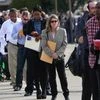 People wait in line to enter the Nassau County Mega Job Fair at Nassau Veterans Memorial Coliseum in Uniondale, New York