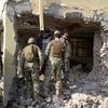 Afghan security forces inspect a building, used by insurgents to launch an attack on Pakistan's consulate in Jalalabad, capital of Nangarhar province, Afghanistan.