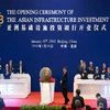Representatives of the founding nations of the Asian Infrastructure Investment Bank (AIIB) applaud as Chinese President Xi Jinping, center, unveils a sculpture during the opening ceremony of the AIIB in Beijing.