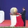 Chinese President Xi Jinping (centre) unveils a sculpture during the opening ceremony of the Asian Infrastructure Investment Bank (AIIB) in Beijing on Saturday