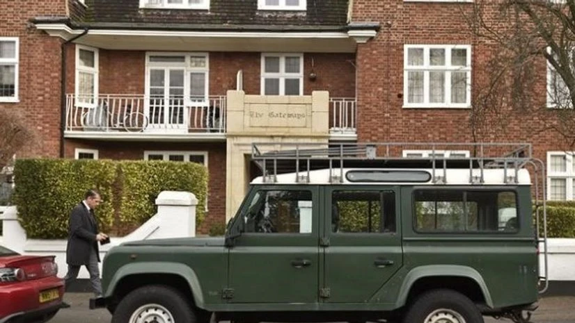 A man walks past a Land Rover Defender parked on a street in London A man walks past a Land Rover Defender parked on a street in London