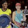 Angelique Kerber, right,  of Germany holds the trophy,  along with runner-up Serena Williams of the United States after the women's singles final at the Australian Open tennis championships in Melbourne