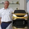 Tata Motors' Head of Advanced and Product Engineering, Tim Leverton, poses with a model of Zica car inside his office at the company's plant in Pimpri
