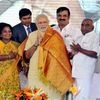 Prime Minister Narendra Modi is presented with a shawl by Tamil Nadu BJP chief Thamizhisai Soundararajan at a public meeting in Coimbatore